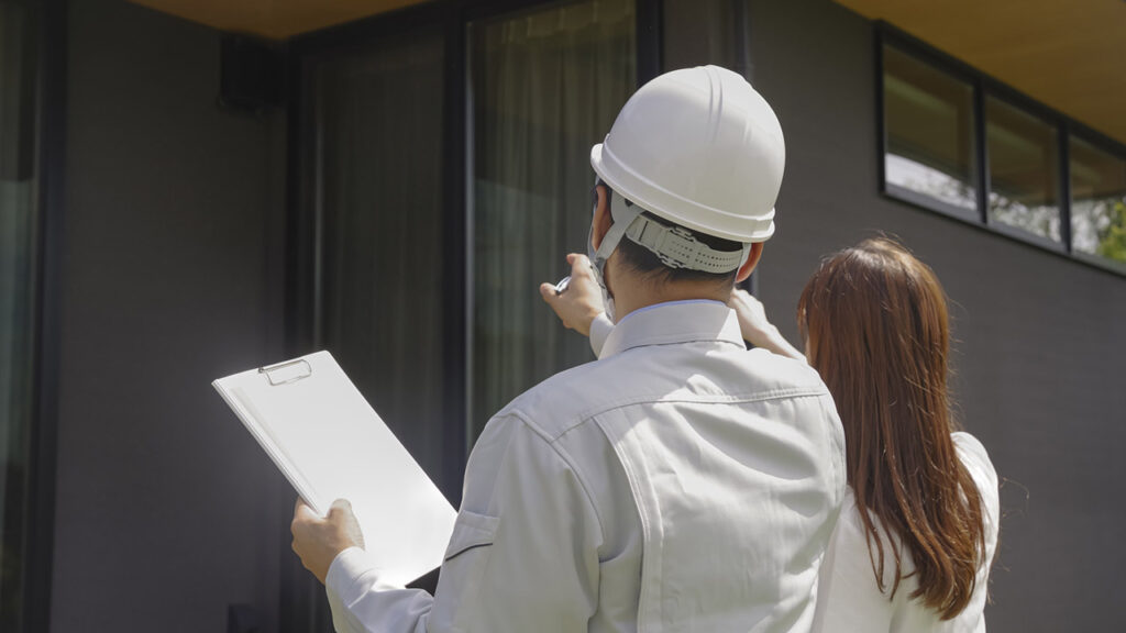 業者と一緒に家を見る画像